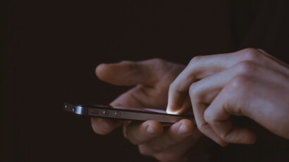 Phone user tapping on screen